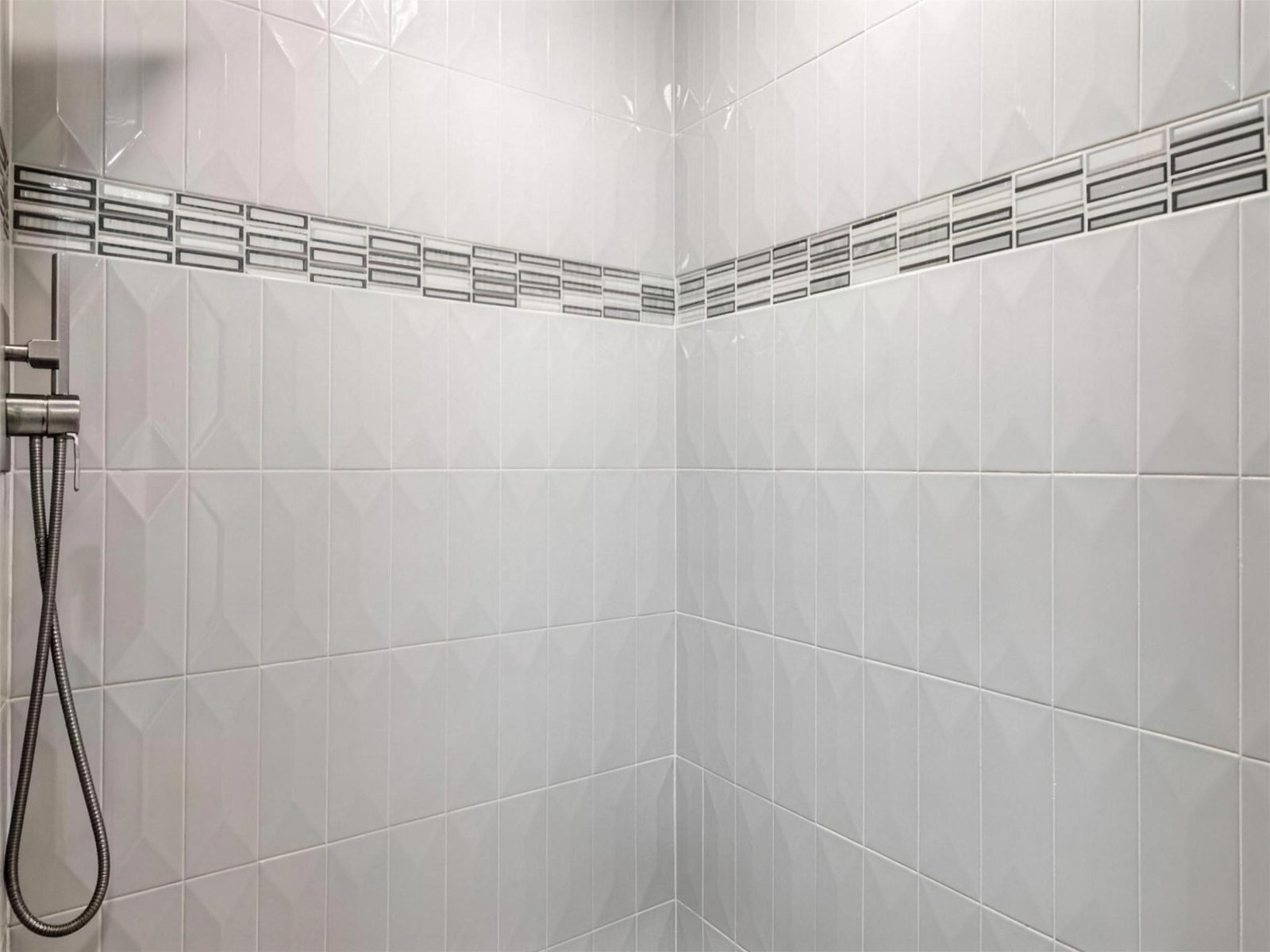 Bathroom remodel in Carrollton, TX — picket tile accent band — UHS Remodeling project