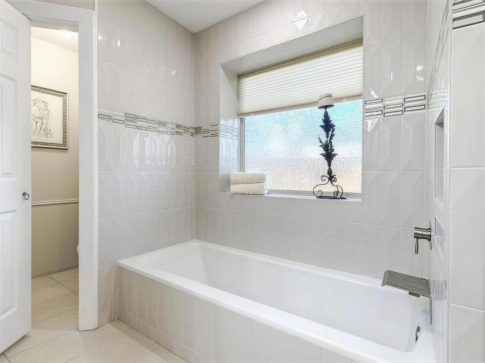Bathroom remodel in Carrollton, TX — tiled alcove soaking tub — UHS Remodeling project