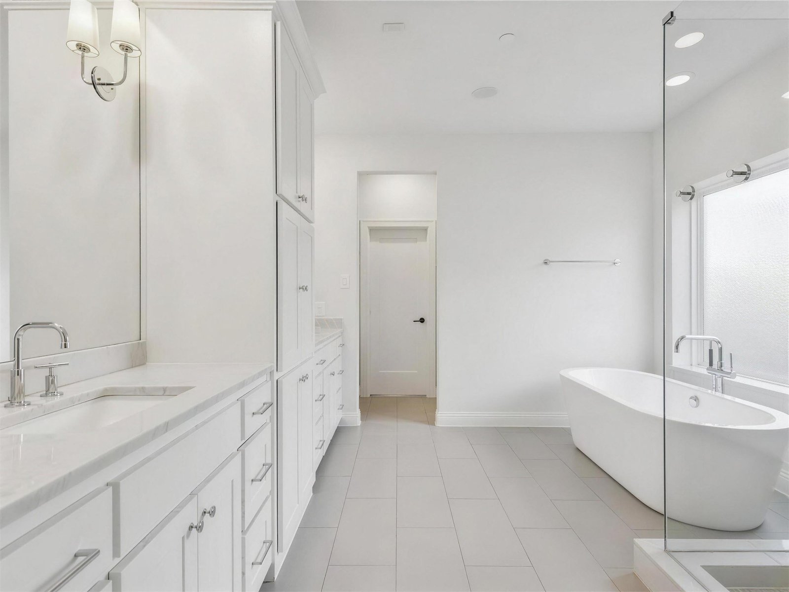 Bathroom remodel in University Park, TX — white double vanity freestanding tub — UHS Remodeling project