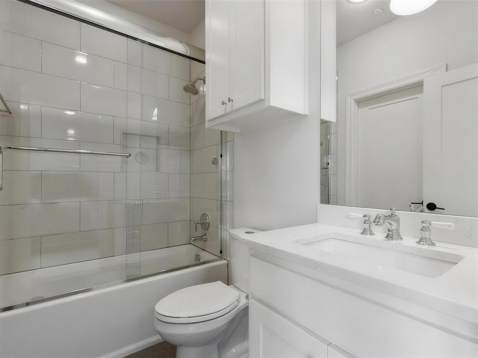 Bathroom remodel in University Park, TX — white tile tub shower — UHS Remodeling project