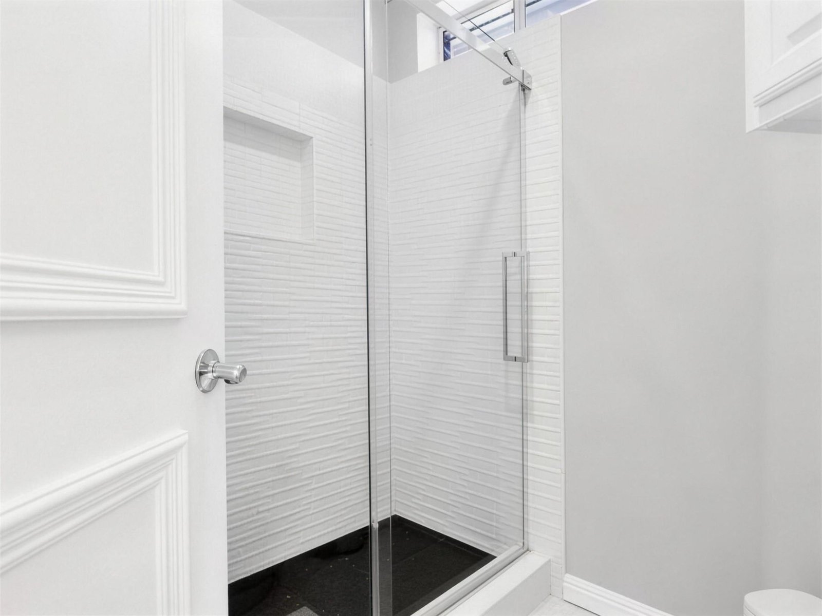 Bathroom remodel in Murphy, TX — white wave tile shower pebble pan — UHS Remodeling project