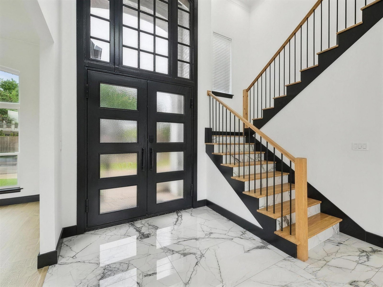 Entryway remodel in Plano, TX — black glass doors oak stair — UHS Remodeling project