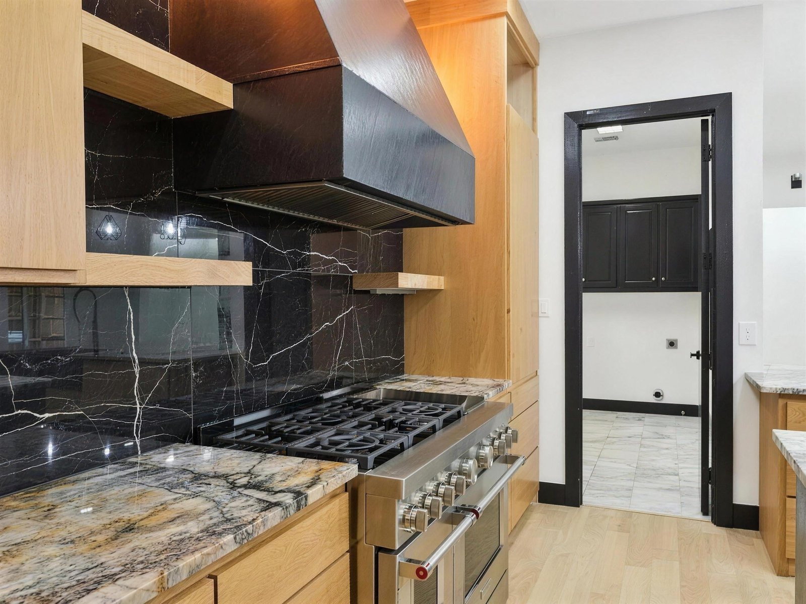 Kitchen remodel in Plano, TX — black marble backsplash range — UHS Remodeling project