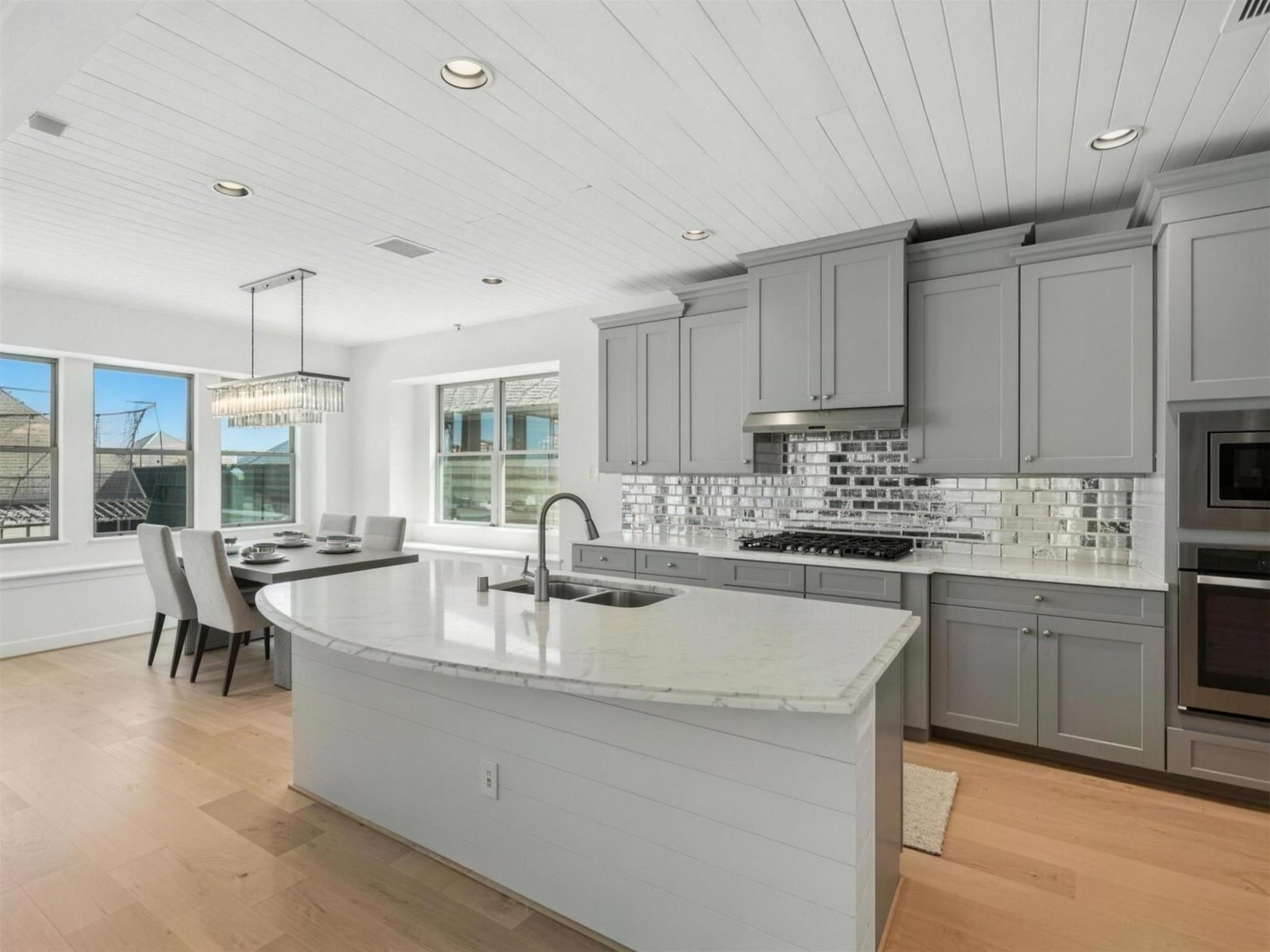 Kitchen remodel in Little Elm, TX — curved marble island — UHS Remodeling project