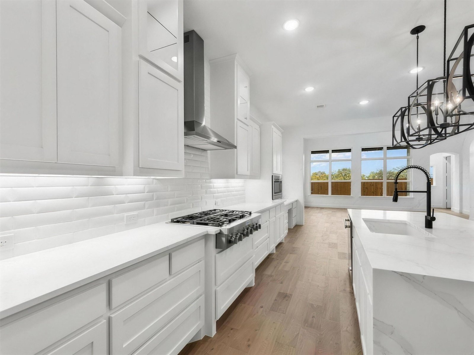 Kitchen remodel in Allen, TX — marble waterfall island gas range — UHS Remodeling project