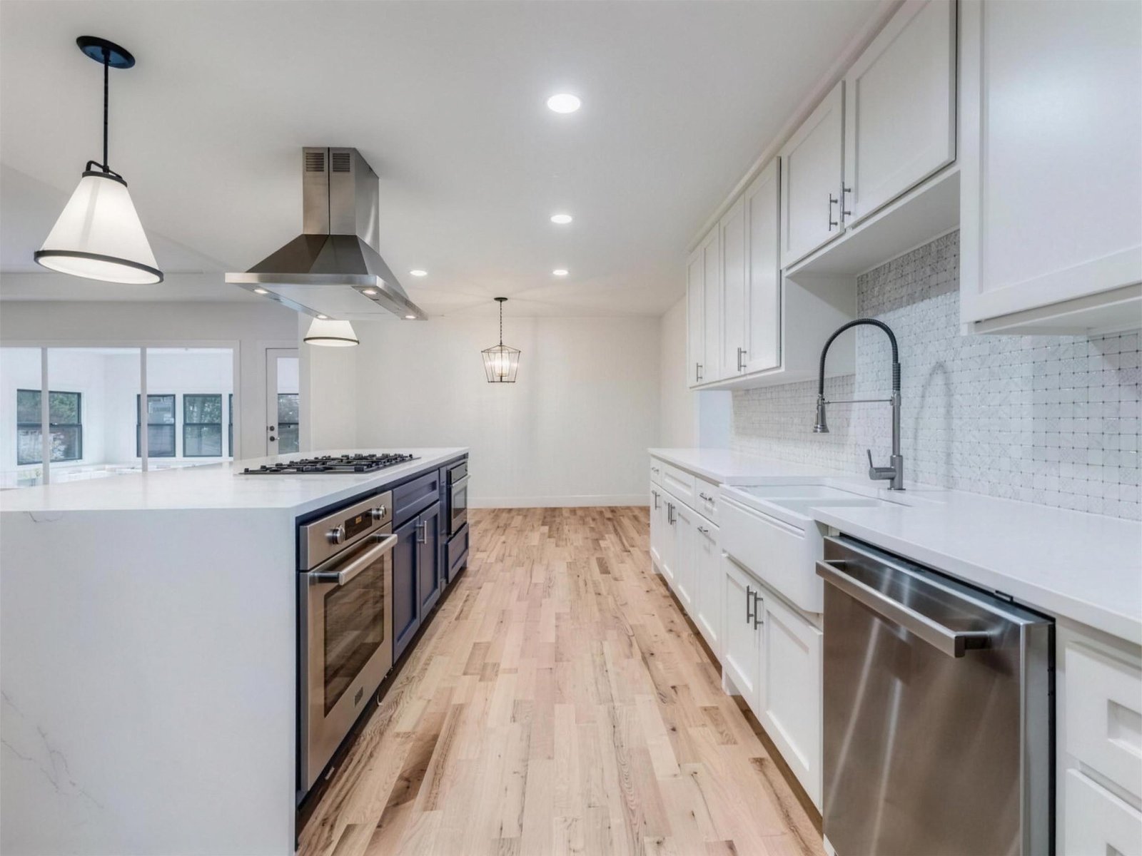 Kitchen remodel in Richardson, TX — waterfall island navy cabinets — UHS Remodeling project