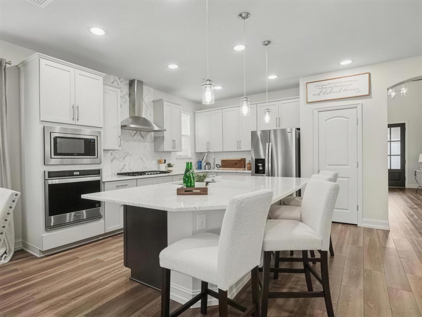 Kitchen remodel in Wylie, TX — white cabinets island hood — UHS Remodeling project