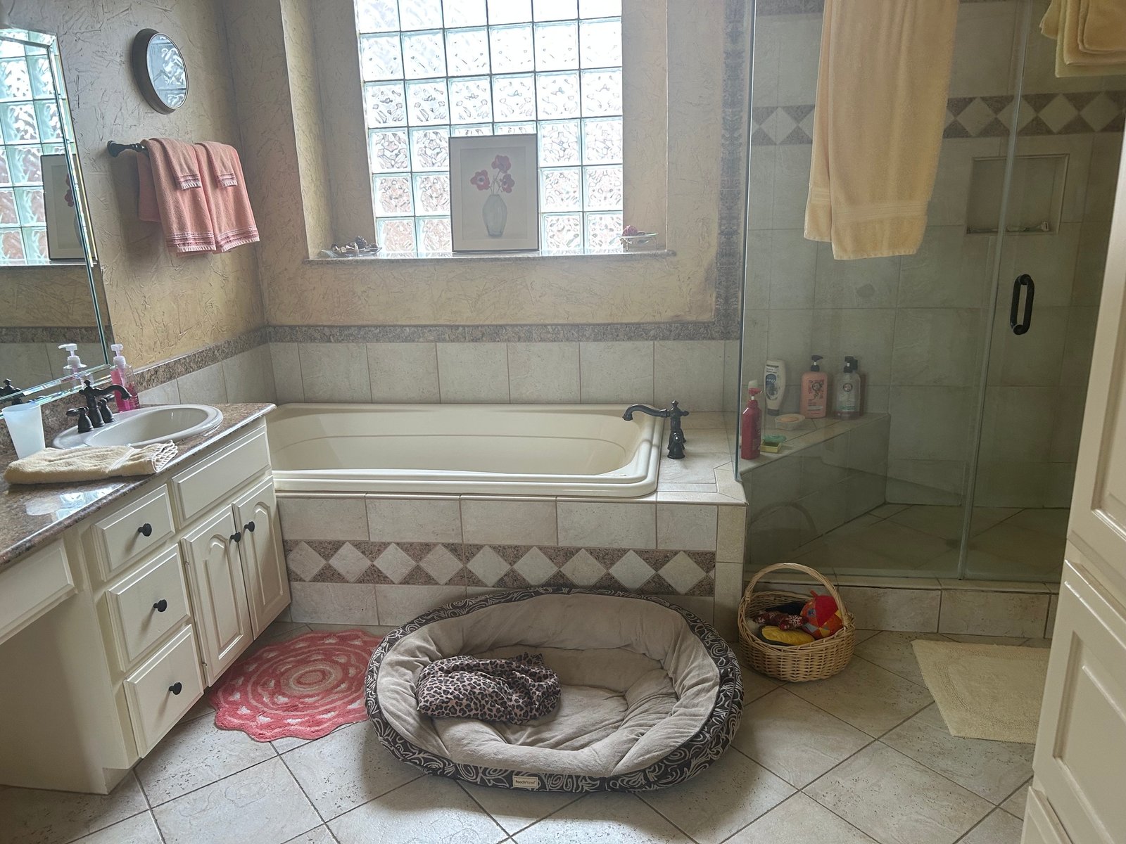 Before: original Plano master bathroom with almond drop-in tub, cream cabinets and diamond-pattern tile