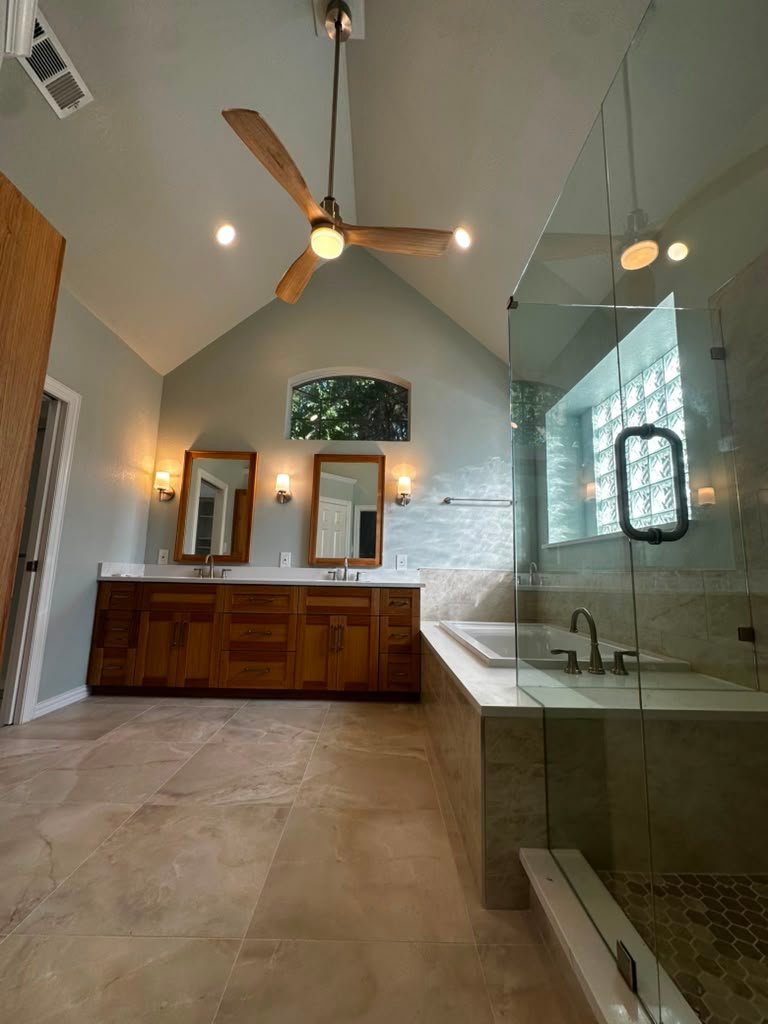 Plano master bathroom remodel viewed from the entry, dual vanity and glass shower