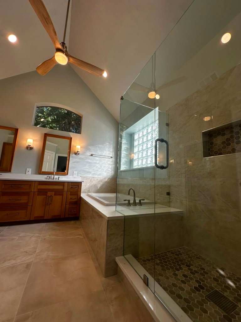 Completed Plano master bathroom remodel with frameless glass shower and vaulted ceiling by UHS Remodeling