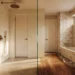 Photorealistic interior-design visualization of a warm cream and brass bathroom with a freshly tiled walk-in shower beside an older tub alcove awaiting work, design study
